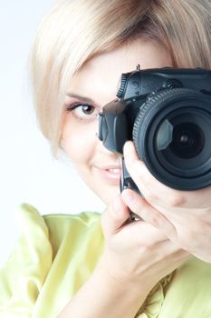 Young and beautiful girl with a professional camera in hand