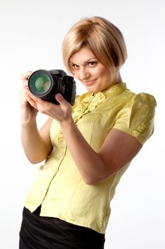 Young and beautiful girl with a professional camera in hand