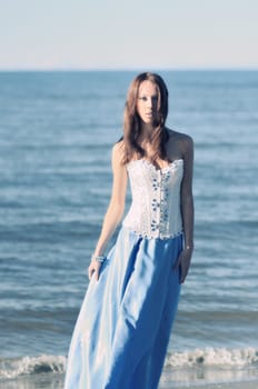 woman in long dress at the sea side.