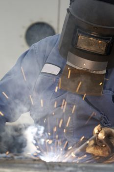 a welder working at shipyard during day