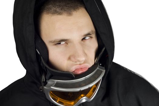 A teenager boy dressed in a snowboarding suit with googles acting fierce and determined.