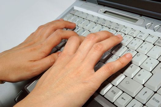 Fingers typing laptop / keyboard / notebook