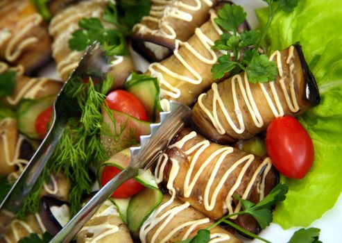 Eggplants filled by cheese and garlic on leaves of salad