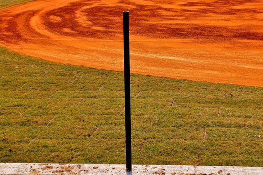 A solitary pole guards the baseball field