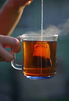 The female hand holds a blue cup with is expected