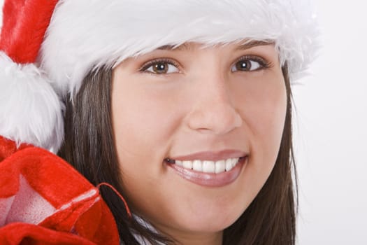 Portrait of a beautiful girl with Santa hat and bag.