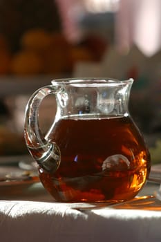 Jug with juice covered by the sun