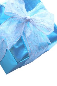 Elegant sky blue colored present with silver ribbons and bow isolated on white.