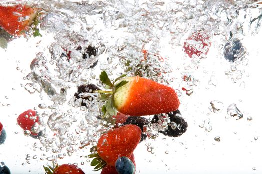 Fresh fruit background in water over white