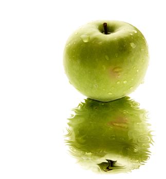 A green apple reflected in a pool of water