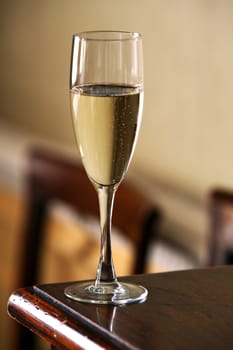 Glass with champagne on a wooden table