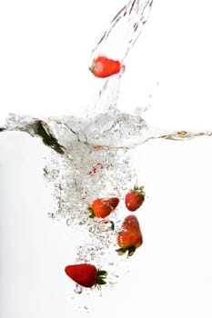 Strawberries in water floating and bubbling