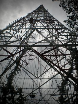 Tall structure under dark clouds and sky