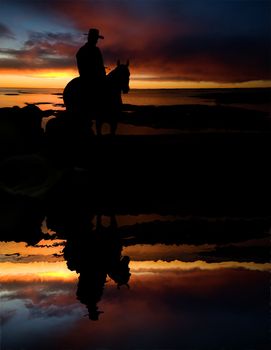 A cowboy on a round up at a watering hold