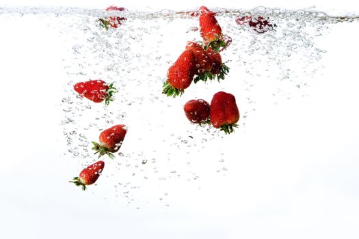 Strawberries in water with bubbles