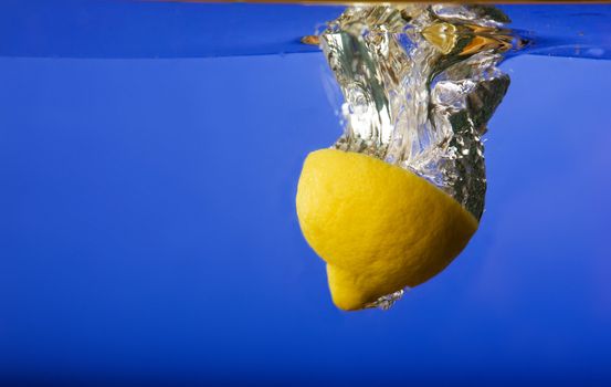 A lemon with a blue background in water