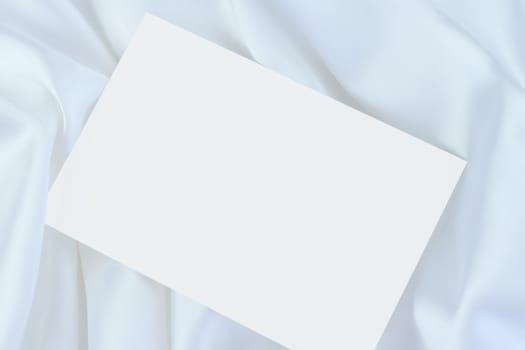 White blank card on white satin