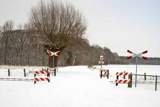 snow landscape  railway track with warning signs
