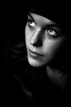 Black and white shot of a pretty girl looking up.

Studio shot.