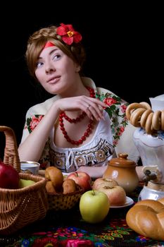 Russian woman drinking tea with samovar on black