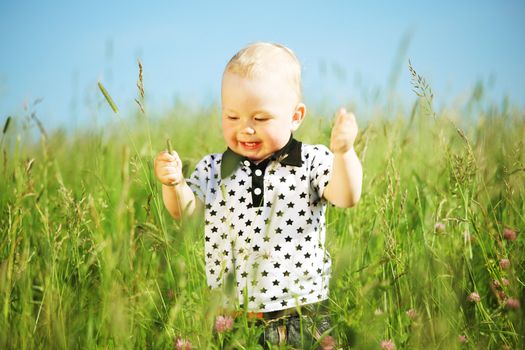 boy joy in green grass