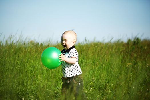 young smile boy play green ball