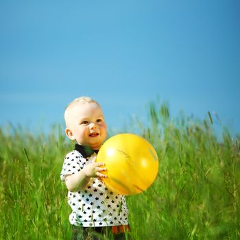 young smile boy play yellow ball