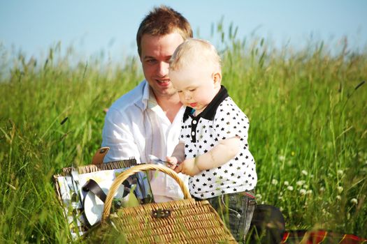 father and son in the grass