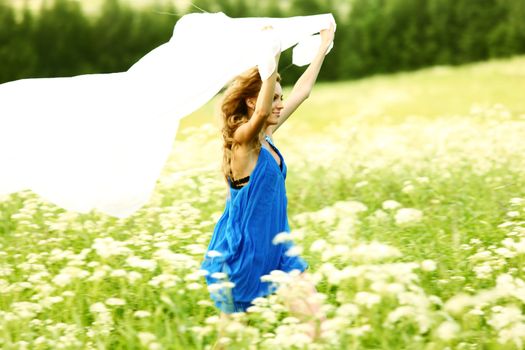  girl run by field fabric in hands fly behind like wings