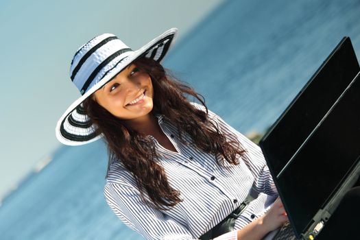 woman work on laptop sea on background