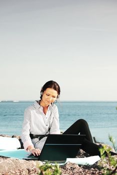 woman work on laptop sea on background