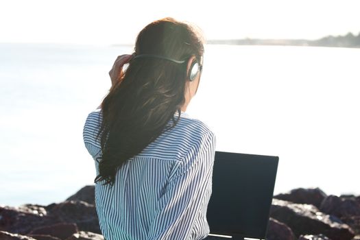 woman work on laptop sea on background