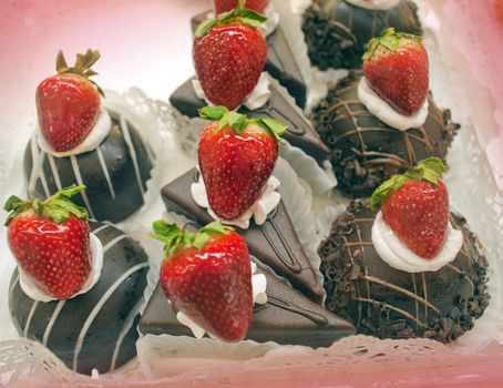 Mini chocolate cakes with strawberry on top