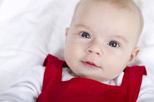 Pretty baby looking at you with her red Christmas dress.