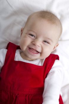 3 Months old girl smiling with no fear, waiting her teeth and hair to grow.