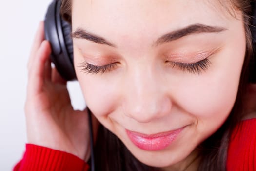 Young girl listening/feeling music her eyes shut. Perhaps classical.