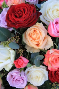 Bouquet with mixed roses in bright colors lile red and pink