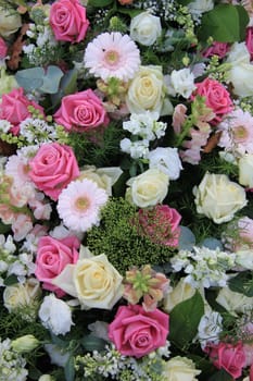 Flower arrangement with roses in white and different shades of pink