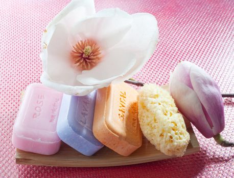 Various scented soaps and white flower