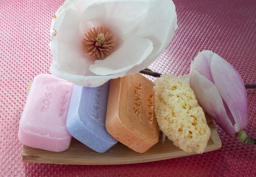 Various scented soaps and white flower
