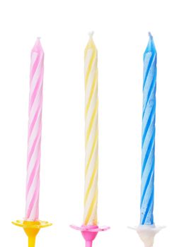 Closeup view of three colorful birthdays candle