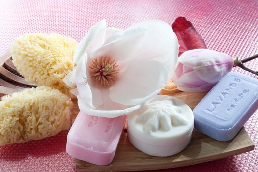 Various scented soaps and white flower
