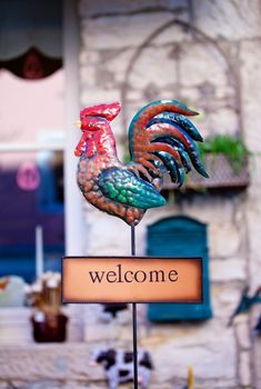 Photo of a Welcome sign with iron rooster