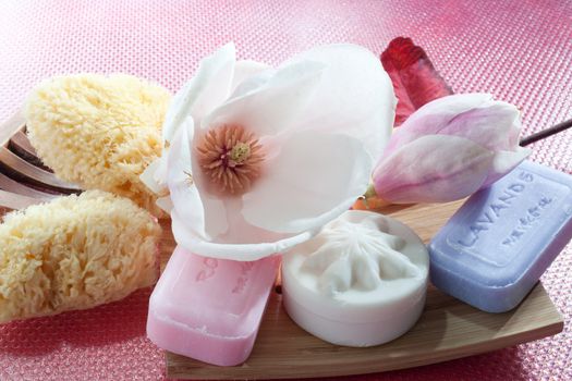 Various scented soaps and white flower