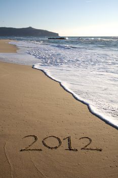 2012 written on the beach vertical in south of italy