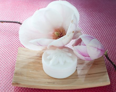 Various scented soaps and white flower