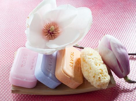 Various scented soaps and white flower