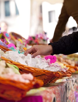 Woman take a soap inside a wicker bastket in the street market