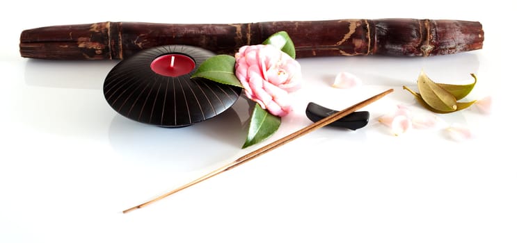 Incense and candle isolated on a white background