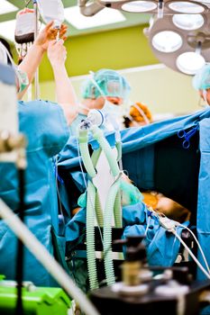 Patient under anesthesia with oxigen mask during surgery in operating room